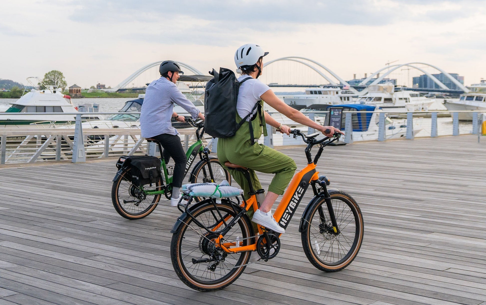 HEYBIKE Cityrun ebike riding on urban boardwalk with waterfront views.