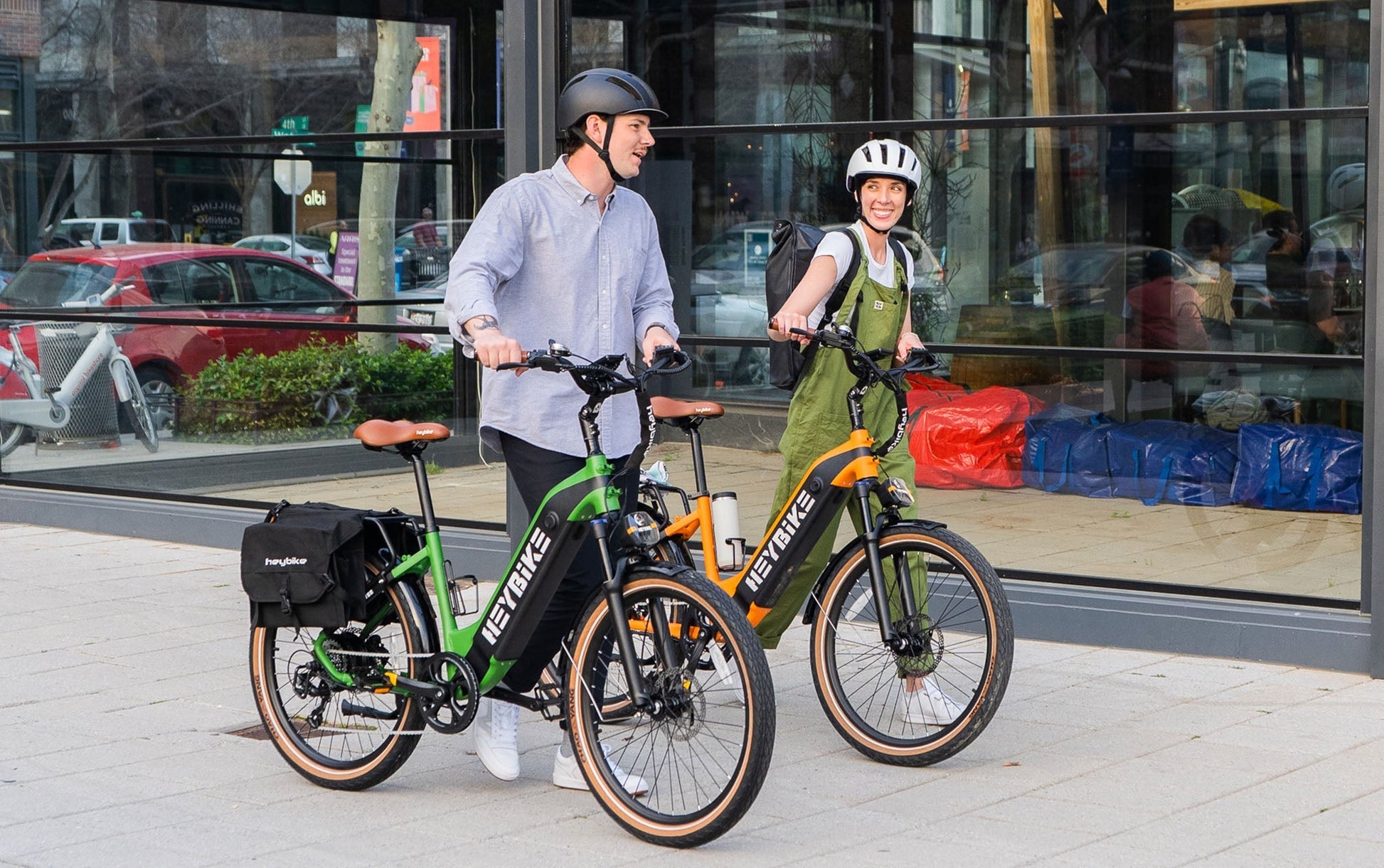 Urban cyclists with HEYBIKE Cityrun ebikes, featuring 1000W peak motors, for stylish commuting.