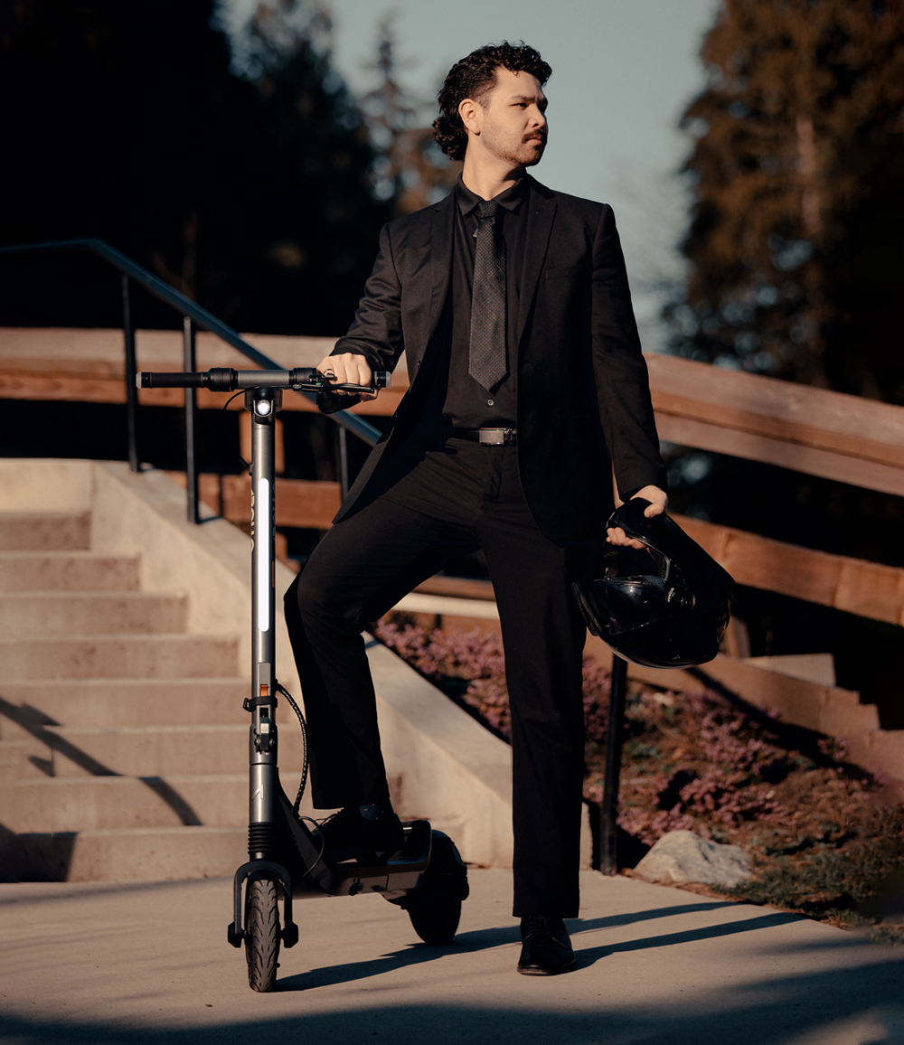 Apollo Go 2024 electric scooter with professional commuter in urban setting.