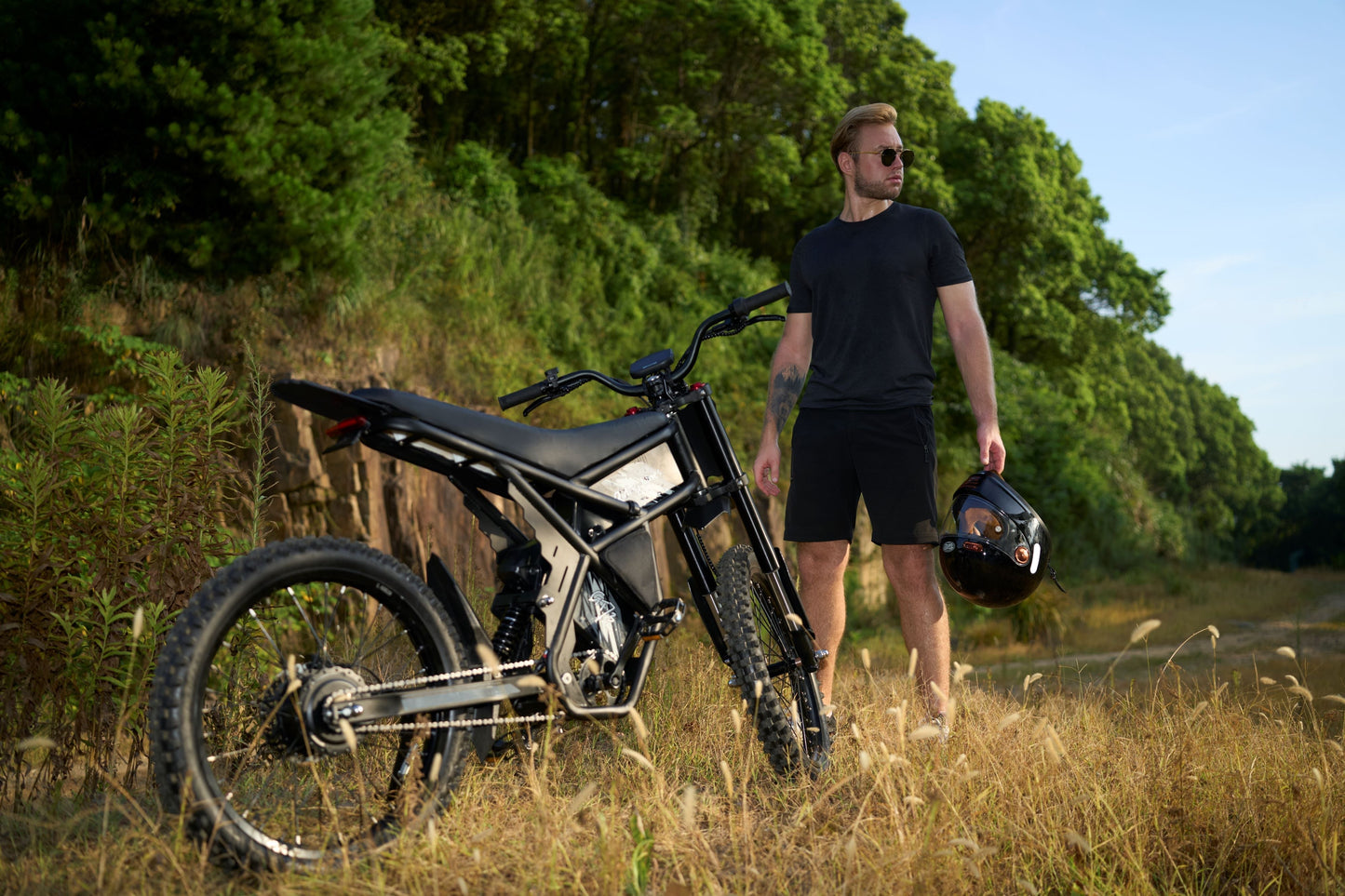 Riding Times GT73 electric motorbike with dual suspension and off-road tires in a scenic outdoor setting.