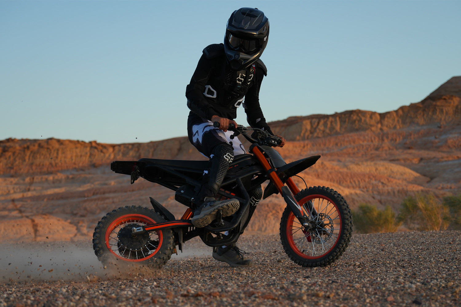 GT54 electric mini motorbike for kids and adults riding off-road in desert terrain