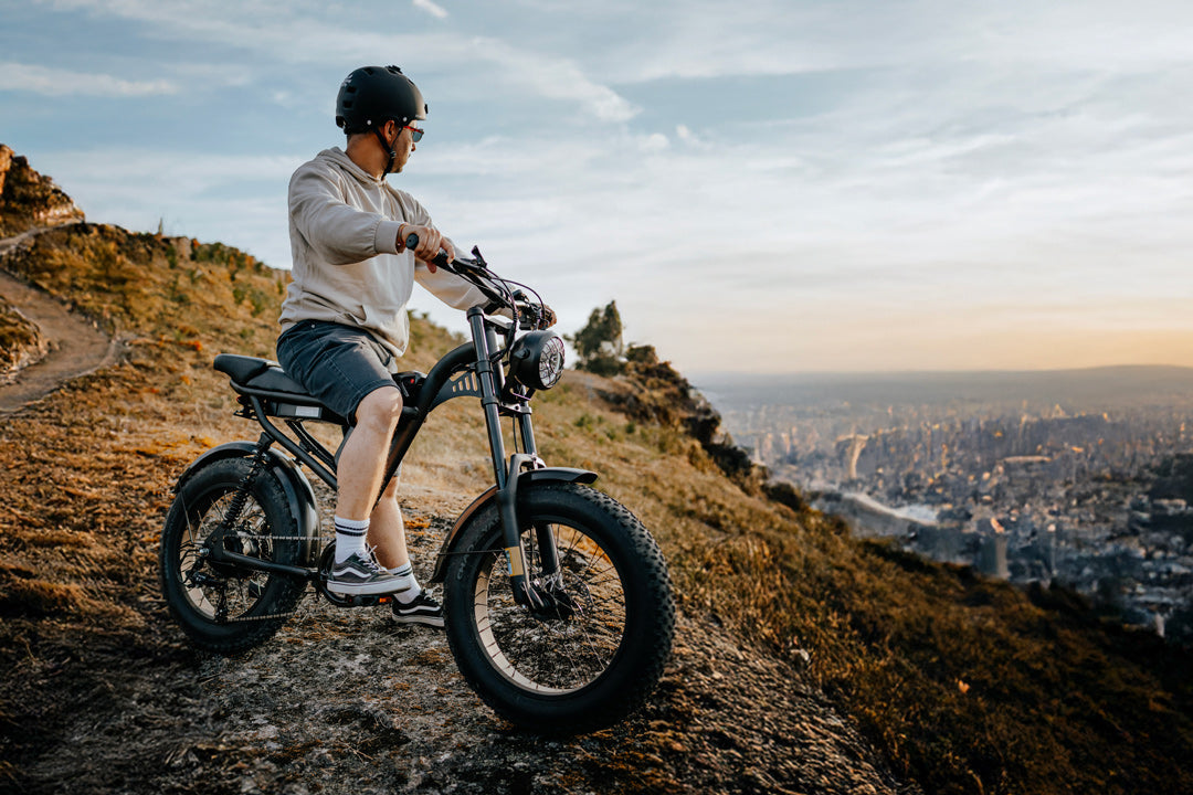 Person riding a Z8 on a hill with a cityscape in the background